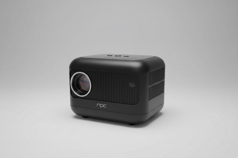 A compact NPC projector placed on a wooden surface, with a visible lens on the front and the brand name on the side.