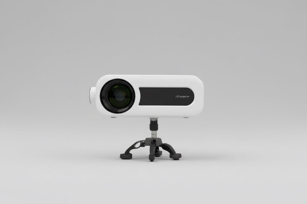 A white MINIO Elite HDMI projector placed on a stand outdoors, with a clear lens visible and a blurred background.