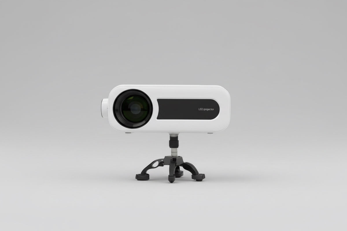A white MINIO Elite HDMI projector placed on a stand outdoors, with a clear lens visible and a blurred background.