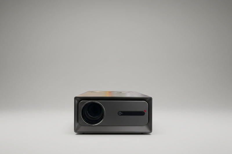 A projector placed on a surface with natural light casting a shadow on its screen.